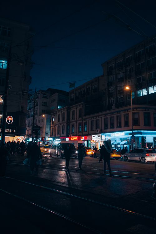 Free Bustling night scene in Istanbul featuring urban streets, trams, and pedestrians. Stock Photo