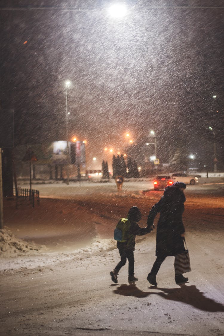 Mother And Child Walking On The Snow