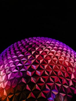 Colorful geometric dome with purple and red lighting in Orlando, Florida at night. by Sofía Morales