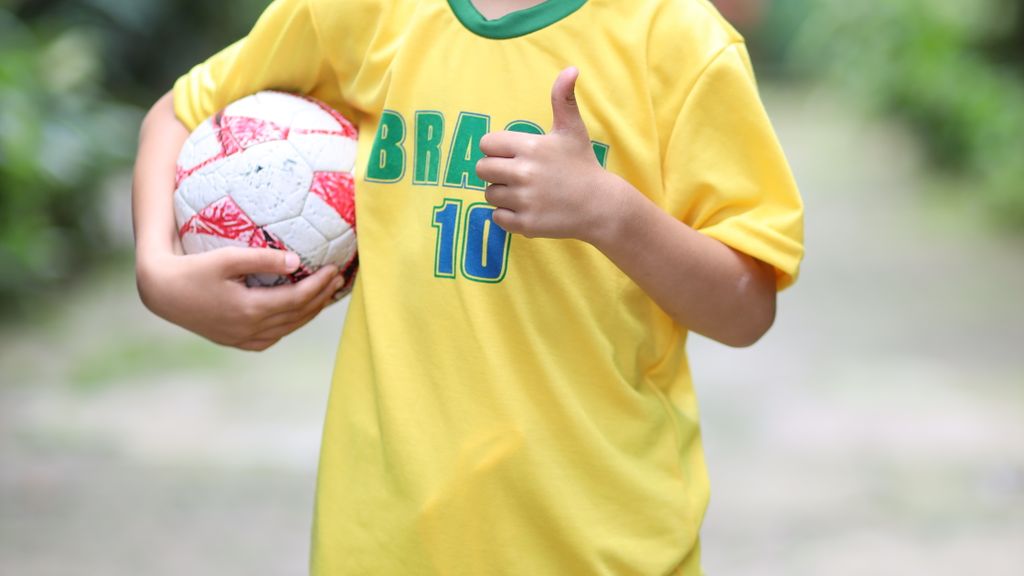 Young Brazilian football fan with football