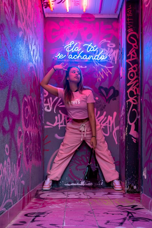 Woman Posing in Pink Clothes among Walls with Graffiti