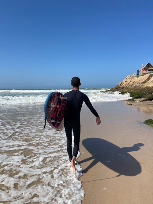 Surfer Carrying His Surfboard