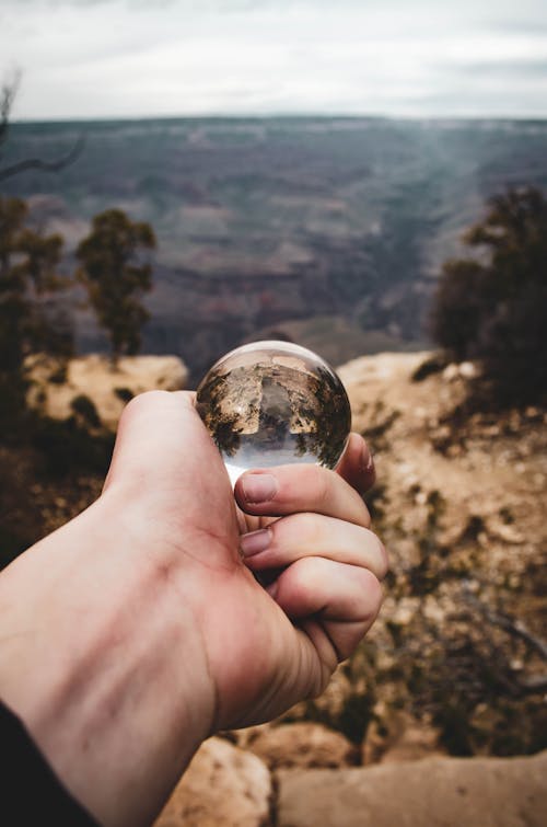 Person Holding a Glass Ball