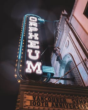 Dramatic neon signage of the historic Orpheum Theatre in Vancouver captured at night.