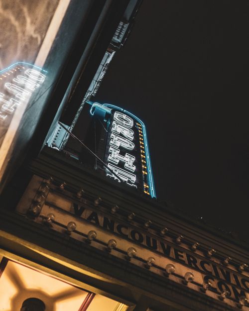 Free Night view of neon lights at Orpheum Theatre in Vancouver, showcasing a classic urban scene. Stock Photo