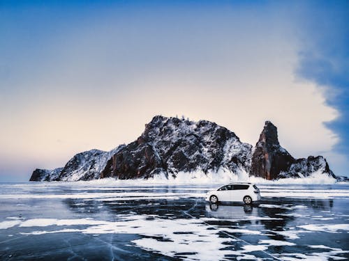 White Car Parked on Frozen Lake