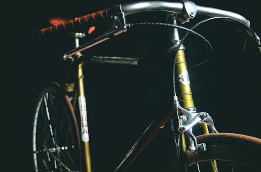 A detailed close-up of a vintage bicycle against a dark background, highlighting its classic design.