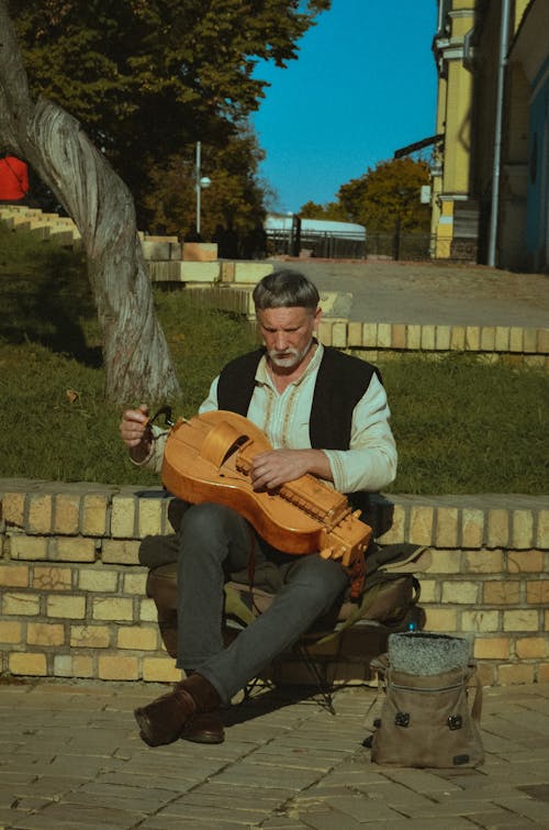 Man Playing a Hurdy-gurdy on a Street 