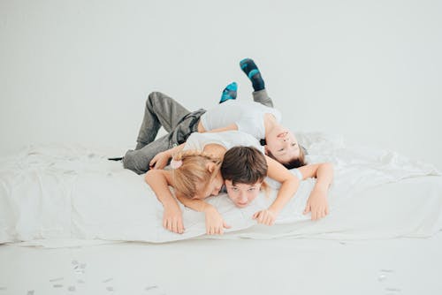 Free Kids Playing on a Bed Stock Photo
