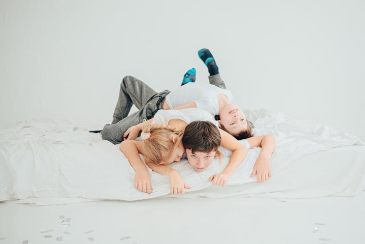 Kids Playing On A Bed