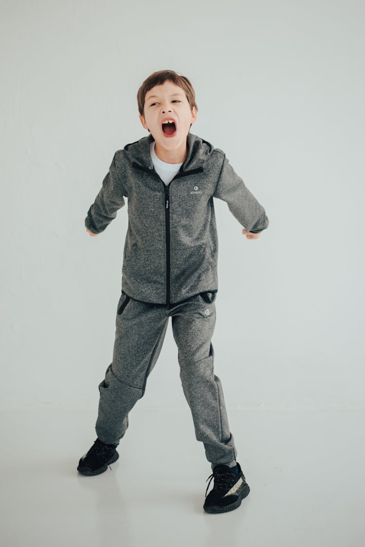 Boy In Gray Jacket And Pants Shouting