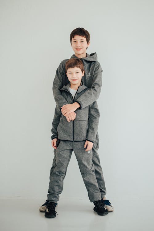 Young Boys in Gray Jacket and Pants Standing Together