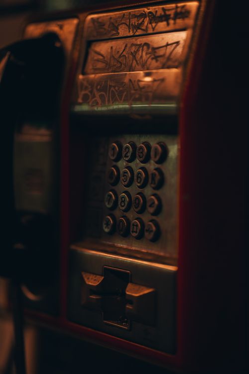 Free Close-up of a graffiti-covered payphone in Cluj-Napoca, Romania. Moody and nostalgic. Stock Photo