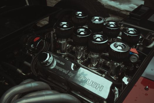 High-performance car engine with air filters and chrome detailing showcasing automotive engineering.