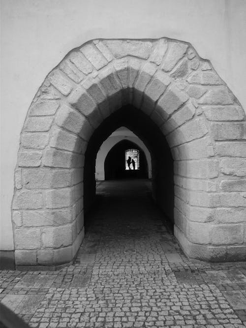 Grayscale Photo of a Tunnel