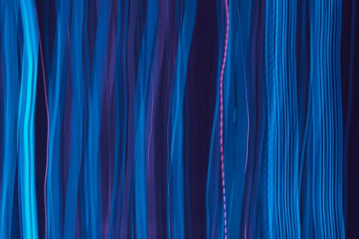 Vertical streaks of blue and purple light creating an abstract pattern.