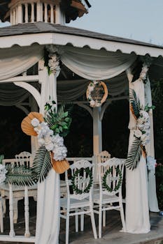 Charming wedding reception gazebo adorned with flowers and elegant decorations.