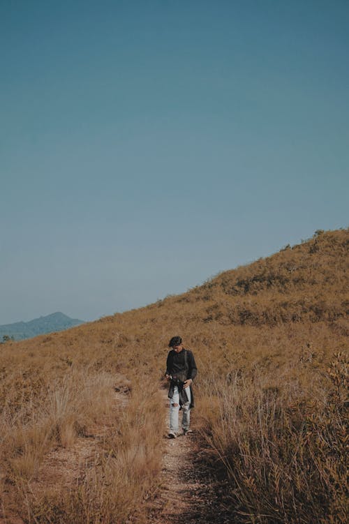 Man Walking on a Pathway at the Hill