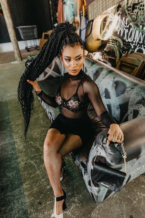 Woman with Dreadlocks Sitting on a Sofa 