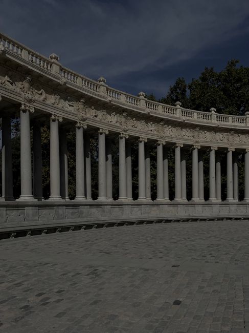 Stunning colonnade in Retiro Park, Madrid, showcasing neoclassical architecture and artistic reliefs. Stunning colonnade in Retiro Park, Madrid, showcasing neoclassical architecture and artistic reliefs.