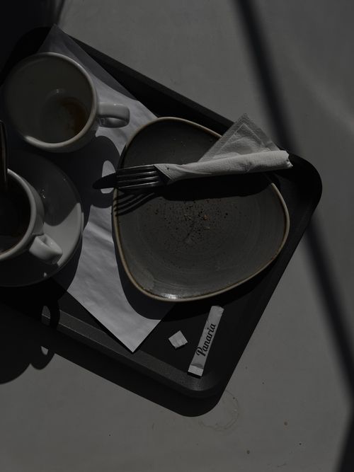 Free Moody minimalist table setting with cups and plate under dramatic lighting. Stock Photo