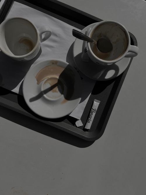 Free Overhead view of ceramic coffee cups and saucers on a tray with shadows. Stock Photo