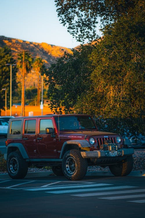 View of a Red Jeep Wrangler on a Parking Lot 