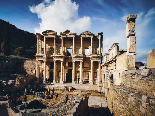 Free Explore the ancient ruins of the Celsus Library in Ephesus with tourists present under a bright, sunny sky. Stock Photo