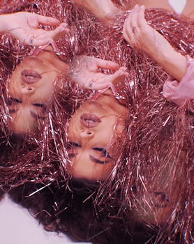 A creative portrait featuring a woman's reflection with a textured, artistic effect.