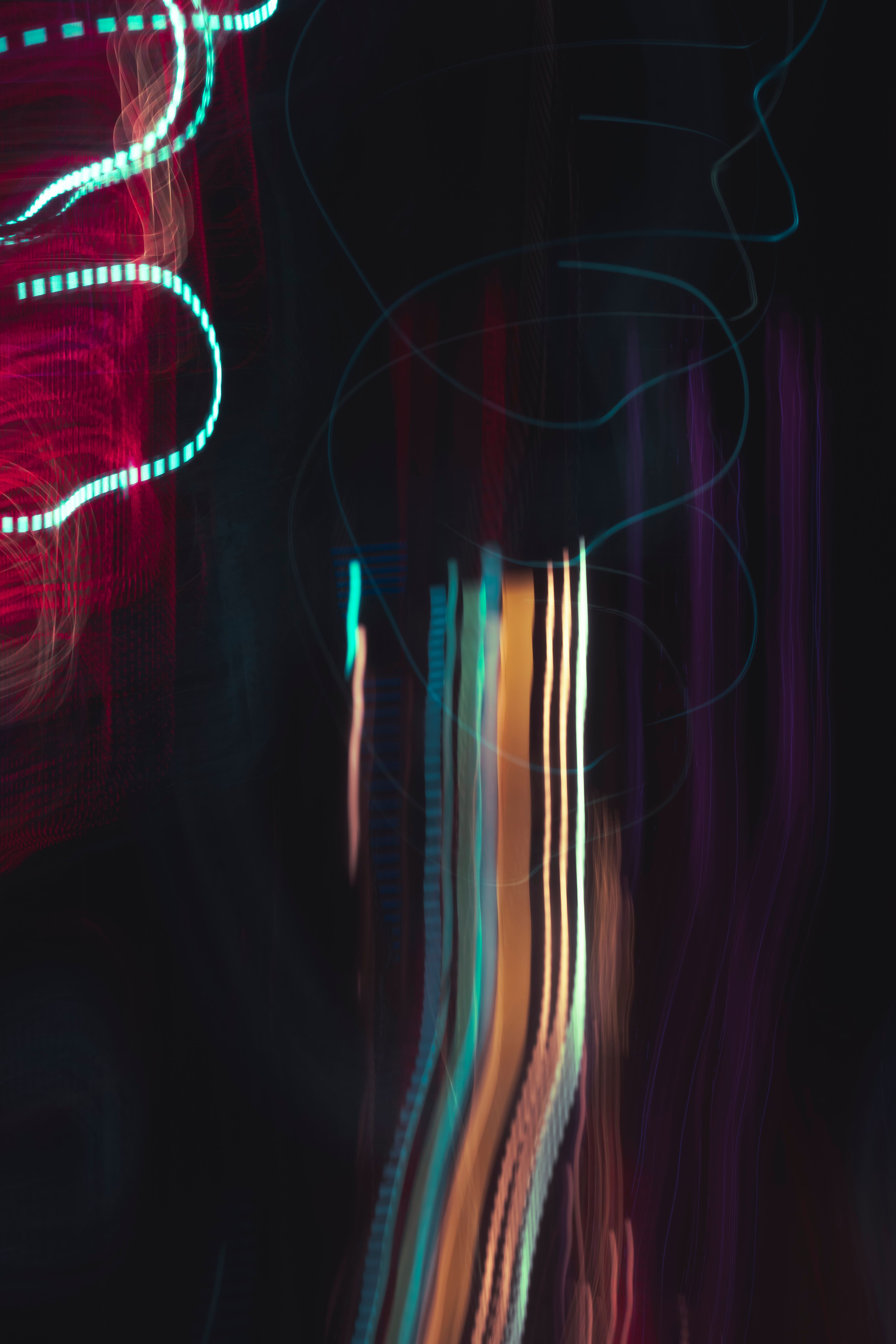 Vibrant abstract light painting with colorful streaks and curves on a dark background.