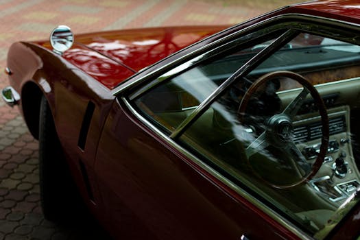 Close-up of a classic vintage car interior showcasing a wooden dashboard and steering wheel in Minsk.