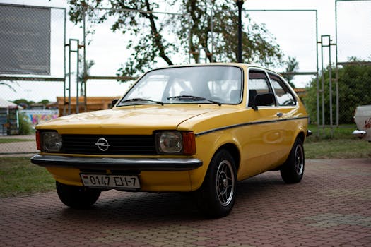 Classic yellow Opel car parked outdoors in Minsk, showcasing retro style.