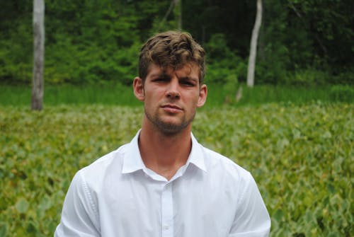 Photograph of a Man in a White Collared Shirt