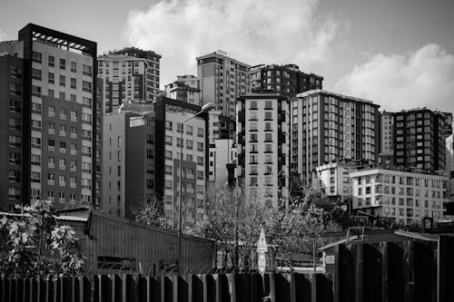 Black and White Photo of Modern Apartment Buildings in City 