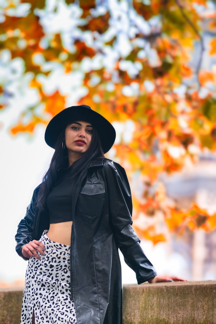 A Woman Wearing Black Leather Jacket And Hat