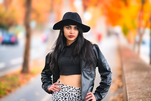 Close-Up Shot of a Woman  in Black Leather Jacket Wearing Black Hat