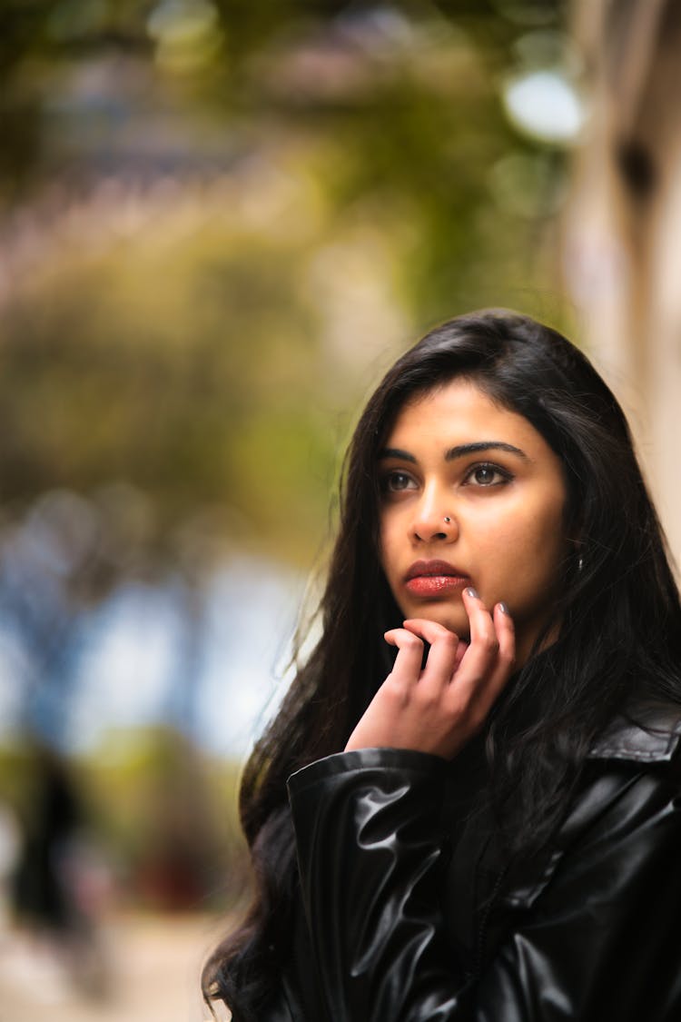 Young Woman In Black Leather Jacket Looking Pensive