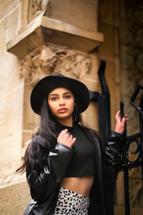 A Woman in Black Leather Jacket and Black Crop Top