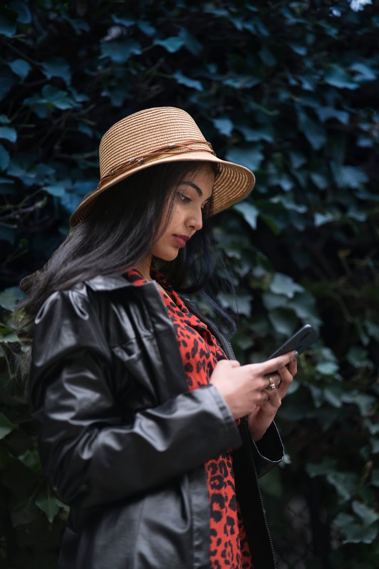 A Woman Holding And Looking At Her Smartphone