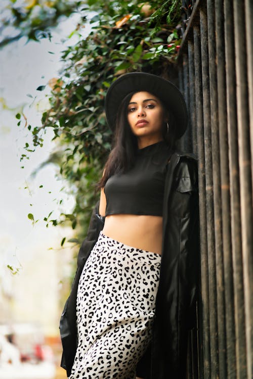 A Woman in Black Leather Jacket and Black Hat