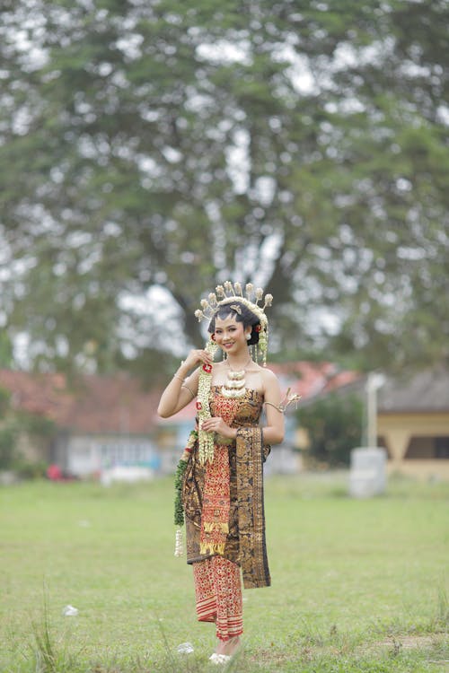 Young Woman in Traditional Clothing Posing Outdoors 