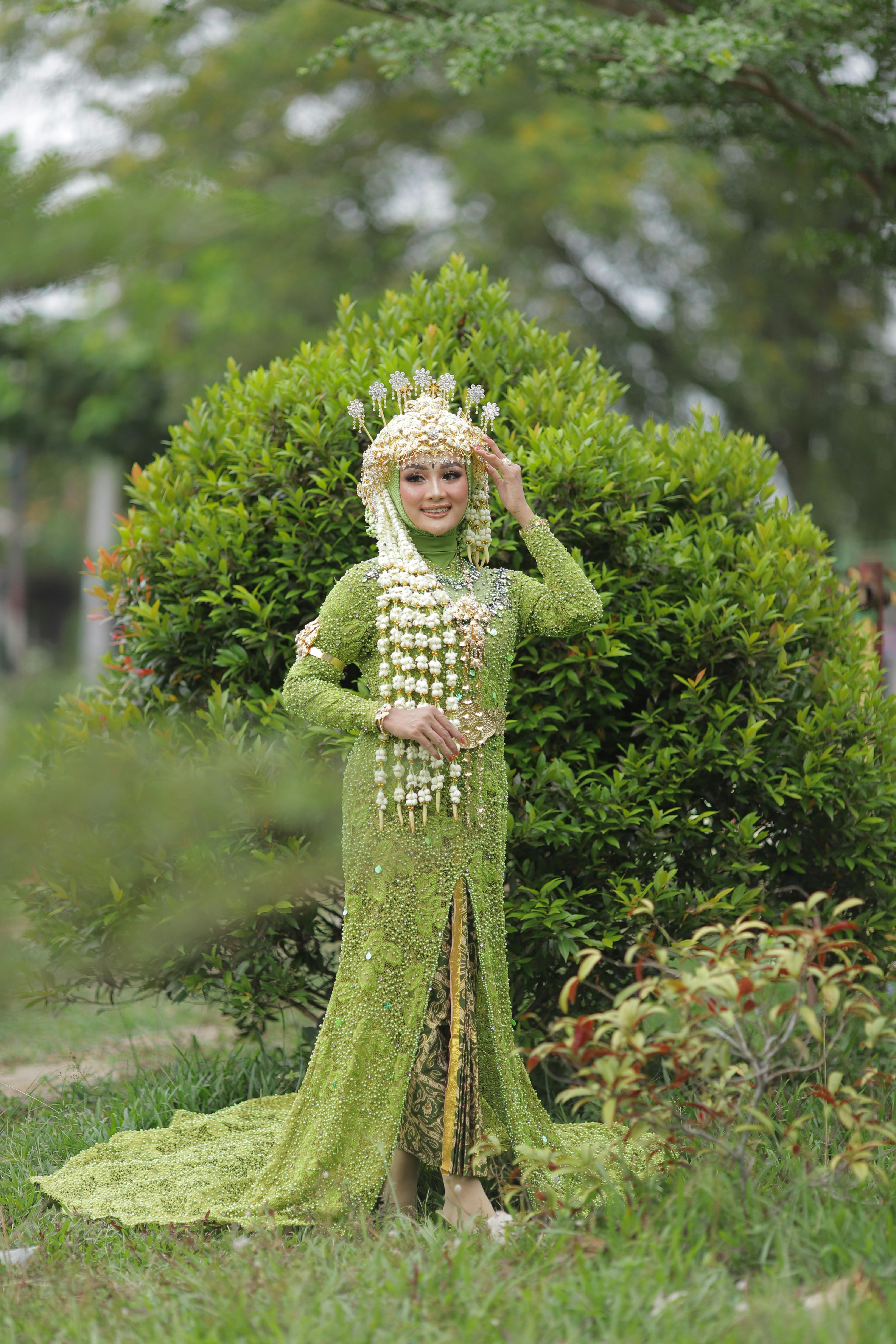 Woman in Green Traditional Dress Standing near Green Plant  Free Stock  Photo