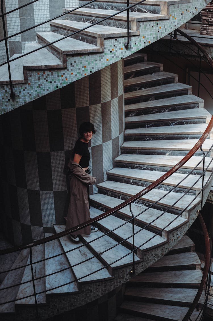 Woman Walking Swirling Staircase