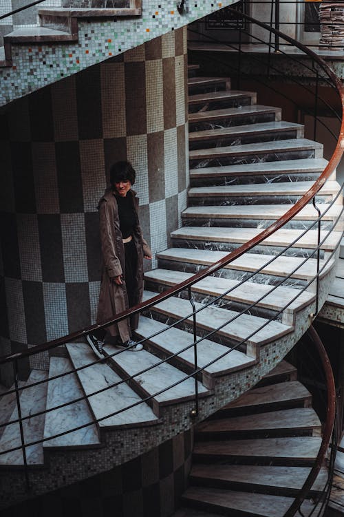 Woman Walking Swirling Staircase