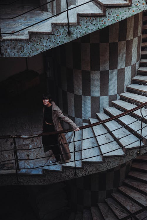 Woman Walking Swirling Staircase