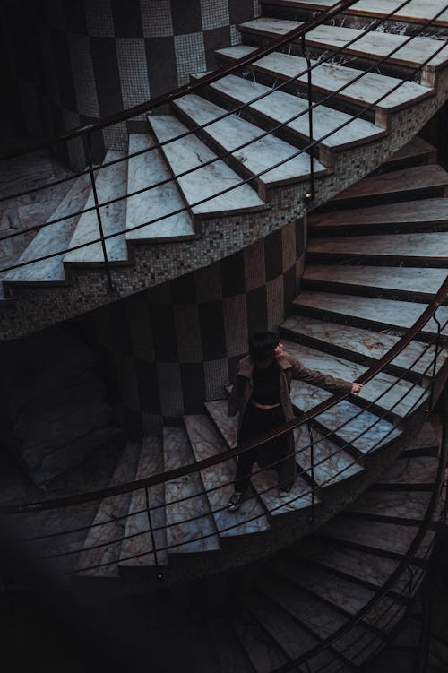 Woman Walking Swirling Staircase