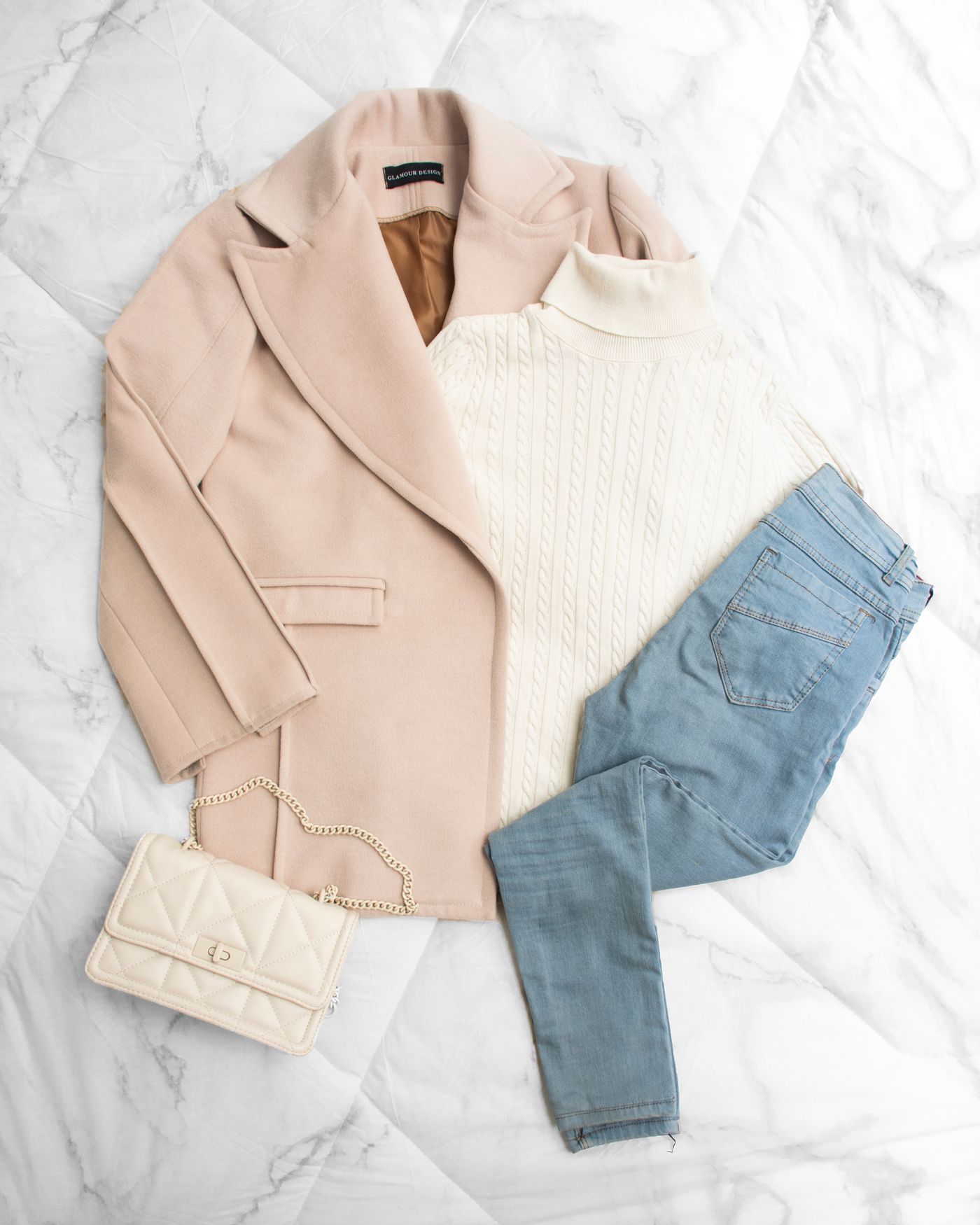Neutral clothing layers arranged in an elegant flat lay without people