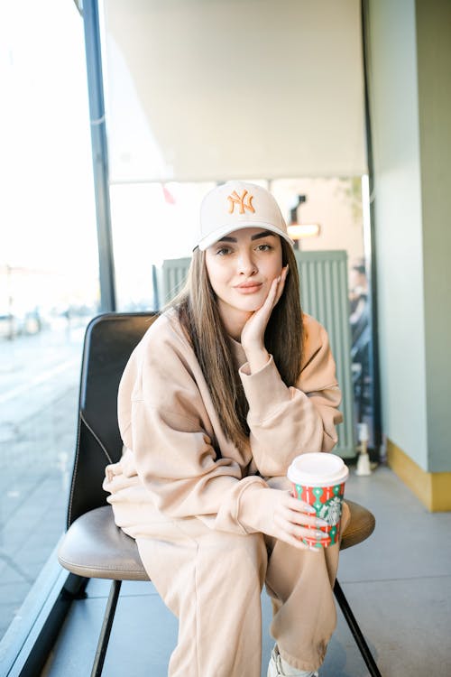 A Woman in Beige Clothes Smiling at the Camera