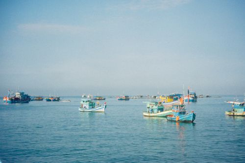 Free A serene view of fishing boats in the blue waters off Phu Quoc, Vietnam. Stock Photo