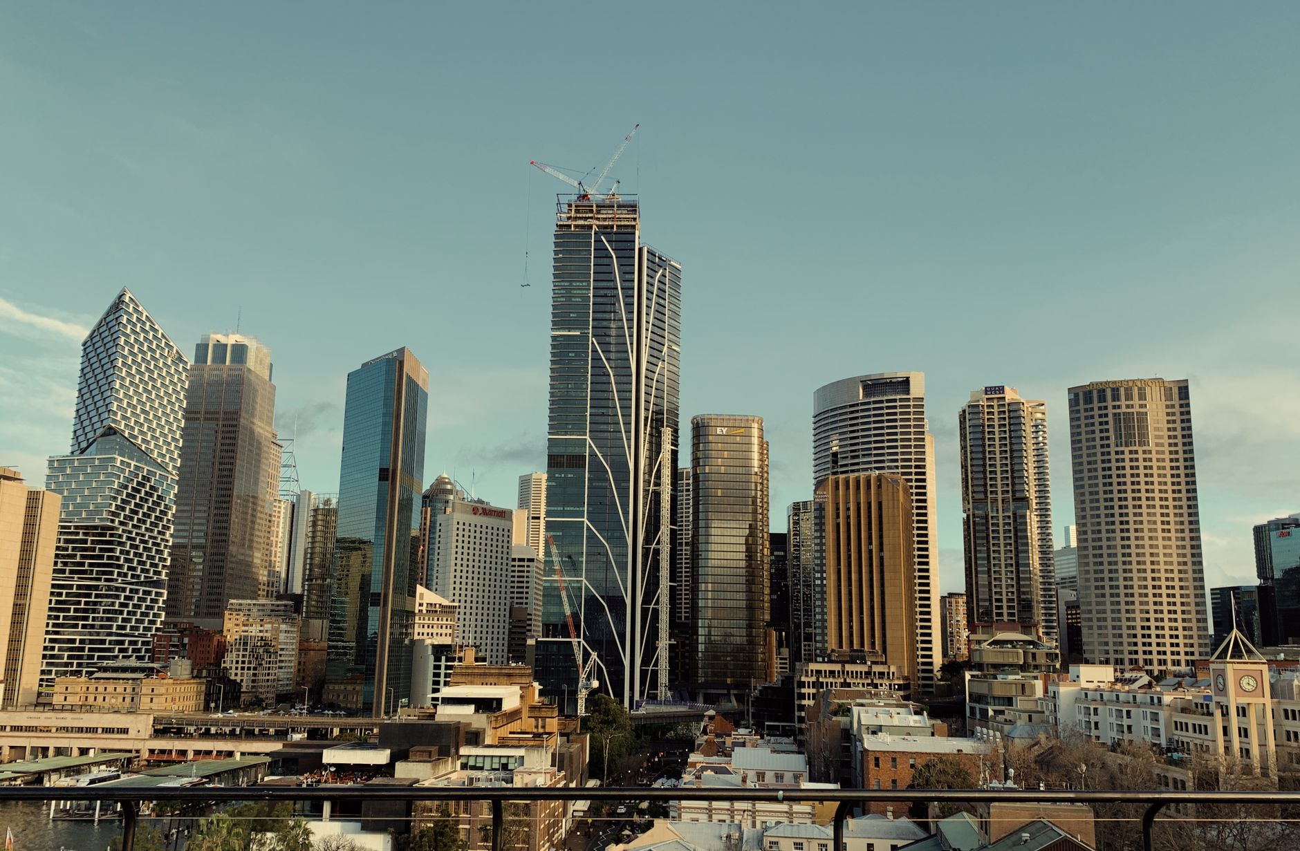 A stunning view of Sydney's skyline featuring modern skyscrapers and iconic architecture under a blue sky.